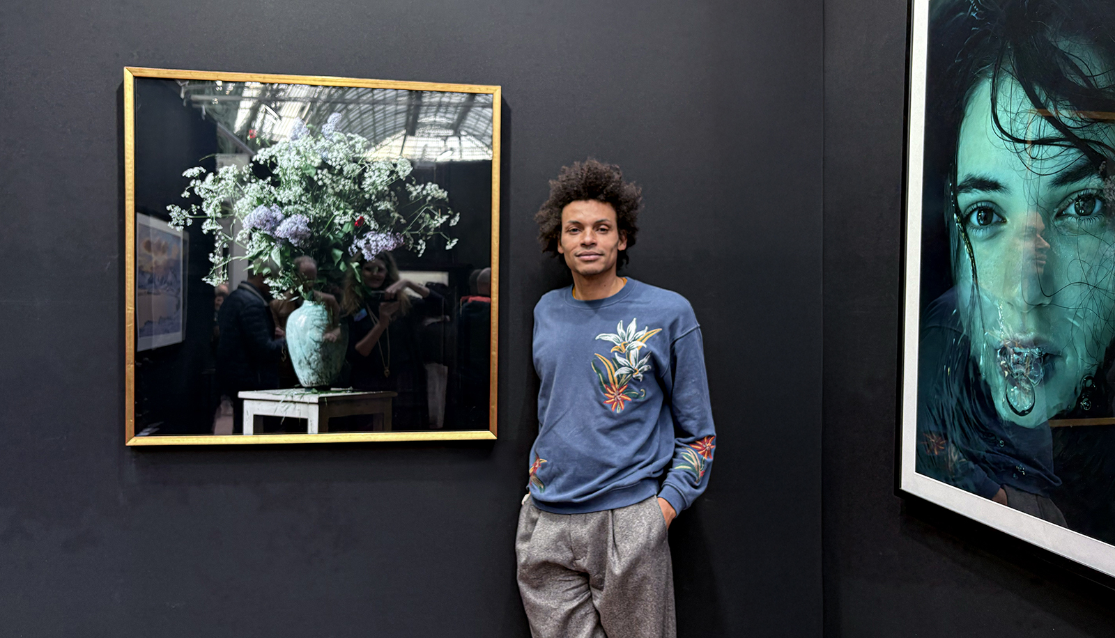 Philip Ka in front of his photography at the Salon des Artistes Francais , Art Capital 2025